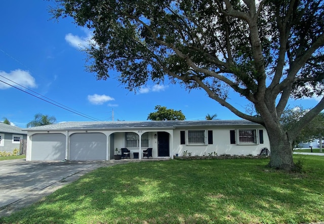 ranch-style house featuring a garage and a front lawn