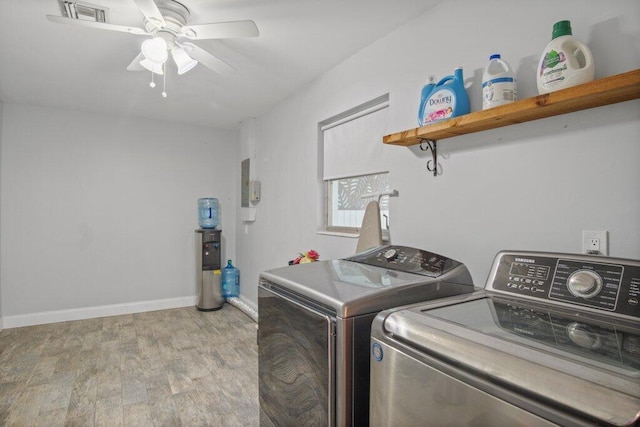 washroom featuring ceiling fan, independent washer and dryer, and light hardwood / wood-style flooring