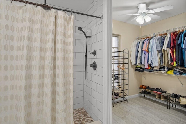 bathroom with curtained shower, hardwood / wood-style flooring, and ceiling fan