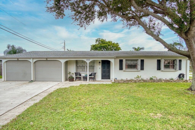 ranch-style house featuring a front yard and a garage