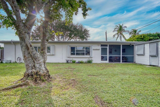 ranch-style house with a sunroom and a front lawn