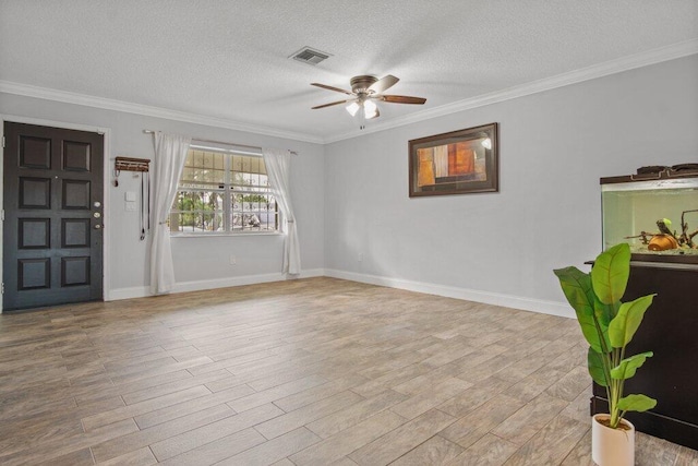 entryway with a textured ceiling, ceiling fan, ornamental molding, and light hardwood / wood-style flooring