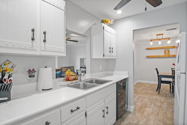 kitchen featuring crown molding, white cabinetry, sink, and light hardwood / wood-style floors