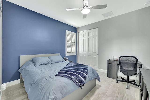 bedroom featuring a closet, light hardwood / wood-style floors, and ceiling fan