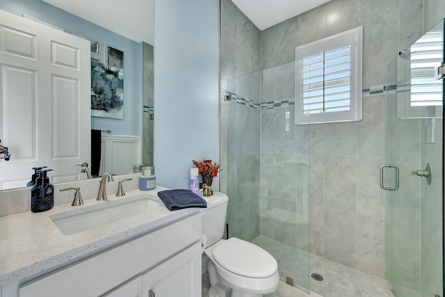 bathroom with vanity, toilet, and an enclosed shower