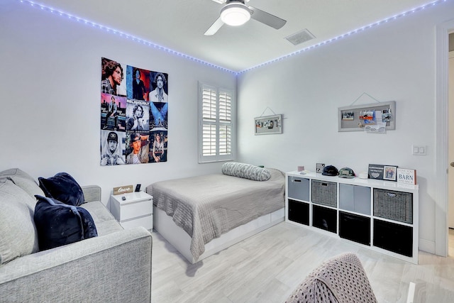 bedroom with ceiling fan and light hardwood / wood-style flooring