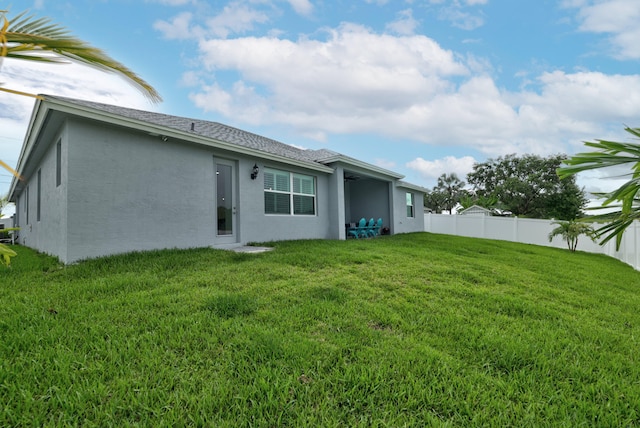 rear view of house with a lawn