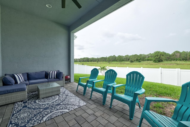 view of patio / terrace featuring ceiling fan and an outdoor living space