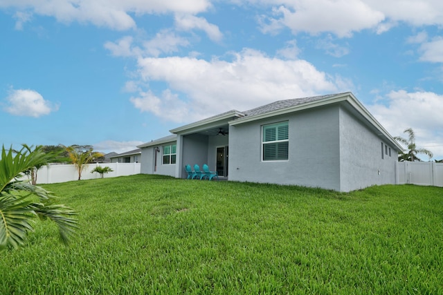 rear view of property with a lawn