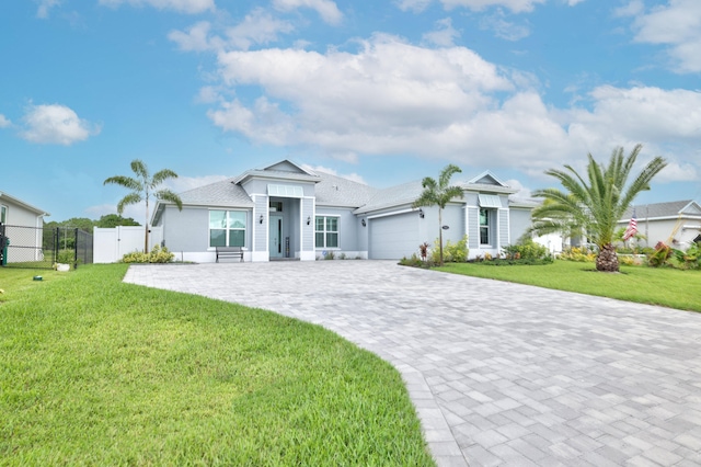 view of front of house featuring a front yard and a garage