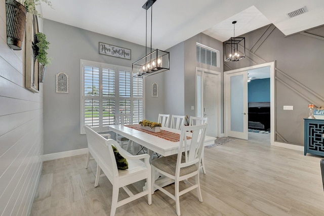 dining room featuring a notable chandelier and light hardwood / wood-style floors