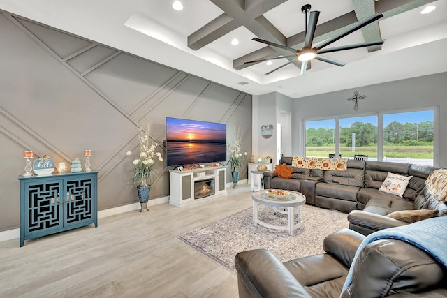 living room with light hardwood / wood-style floors, beamed ceiling, coffered ceiling, and ceiling fan