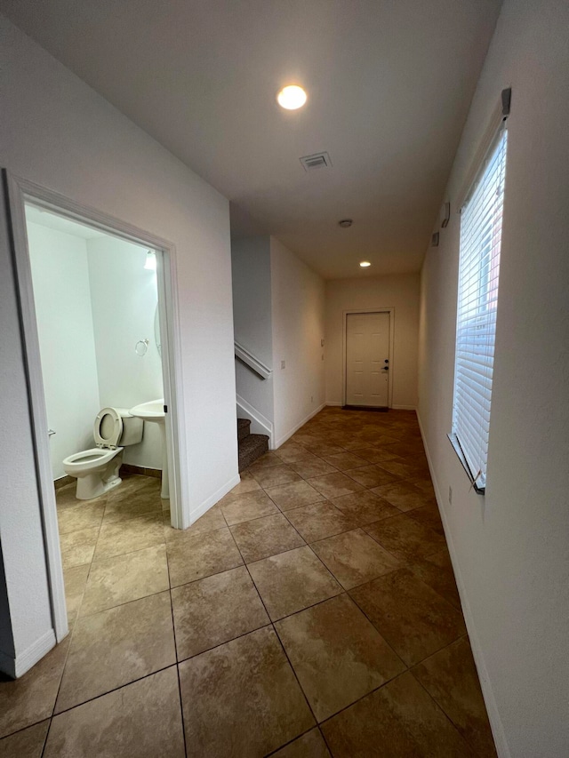 hallway with light tile patterned floors