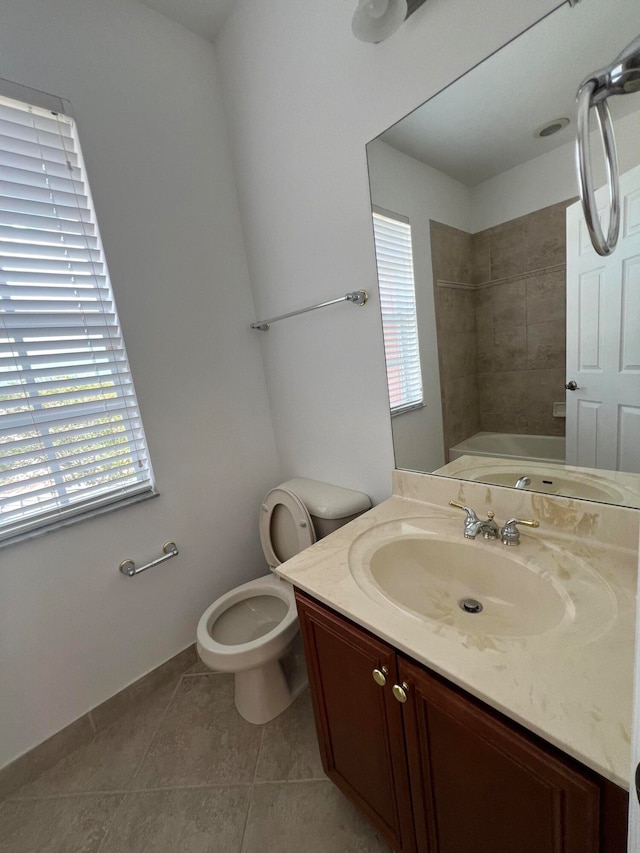 full bathroom featuring vanity, toilet, tile patterned floors, and a wealth of natural light