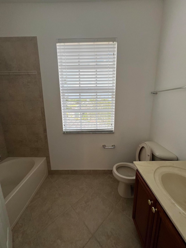 full bathroom featuring toilet, plus walk in shower, vanity, and tile patterned flooring