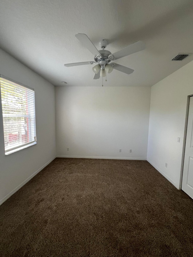 carpeted empty room featuring ceiling fan