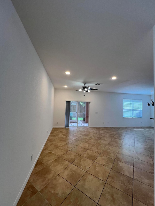 unfurnished room with light tile patterned flooring and ceiling fan