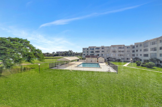 view of pool featuring a yard