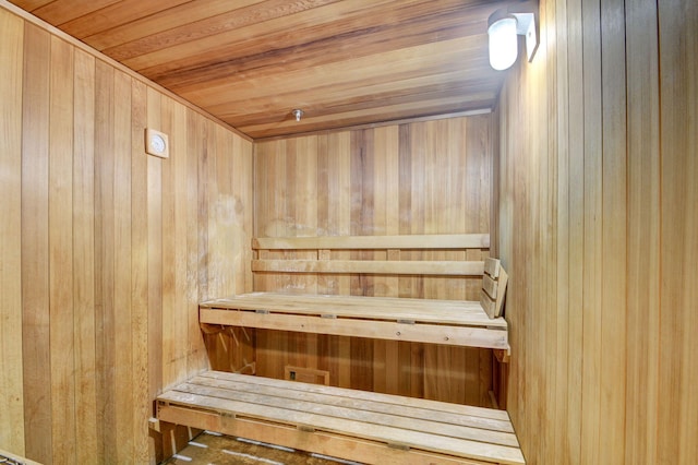 view of sauna with wood walls and wooden ceiling