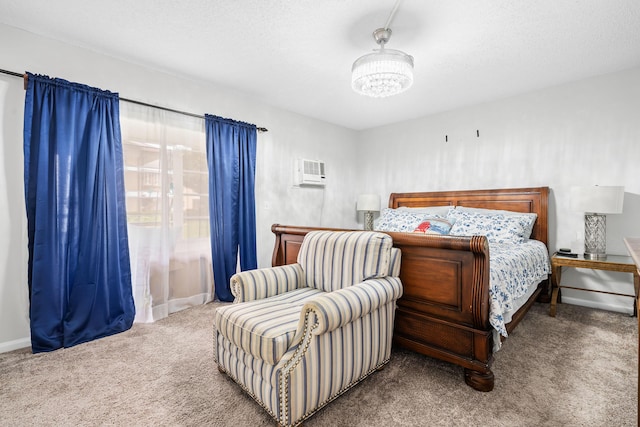 bedroom featuring carpet, a textured ceiling, and a wall unit AC