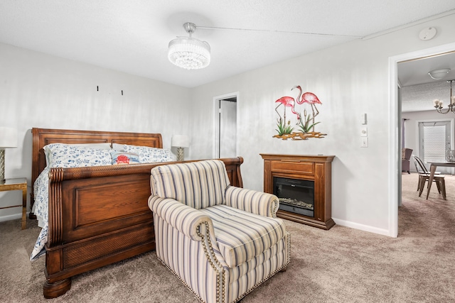 bedroom with carpet flooring, a textured ceiling, and an inviting chandelier