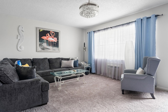 carpeted living room with a notable chandelier and a textured ceiling