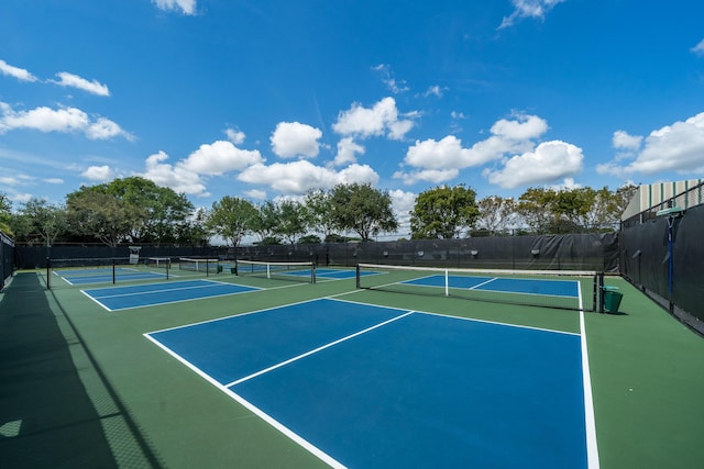 view of tennis court with basketball hoop