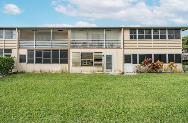 back of house with a lawn