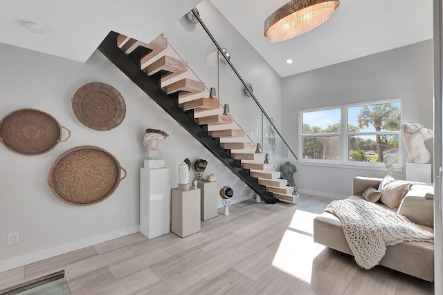 staircase featuring a chandelier