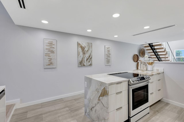 kitchen featuring dishwasher, a chandelier, sink, stainless steel range with electric cooktop, and hanging light fixtures