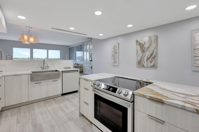 kitchen featuring white refrigerator, kitchen peninsula, white cabinetry, black electric cooktop, and a center island