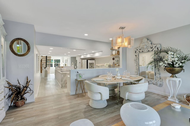 interior space with light hardwood / wood-style floors and a water view