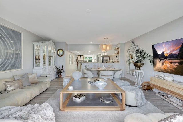 living room featuring a water view and light hardwood / wood-style flooring