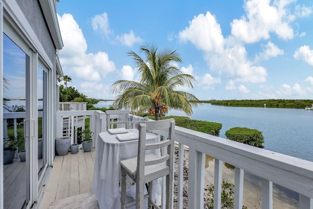 balcony with a water view and a grill