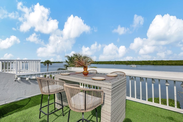 view of yard featuring a patio, a water view, and an outdoor fire pit