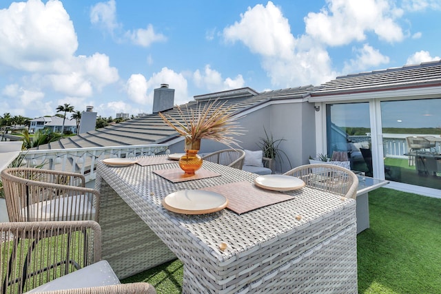 exterior space featuring an outdoor living space with a fire pit and a water view