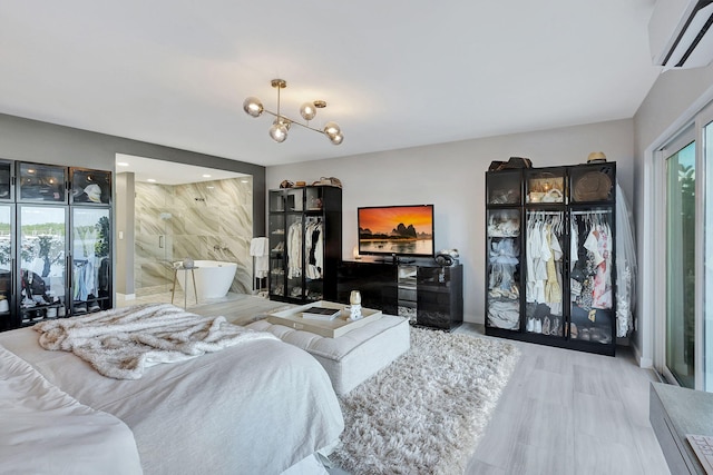 bedroom featuring an inviting chandelier and a wall mounted AC