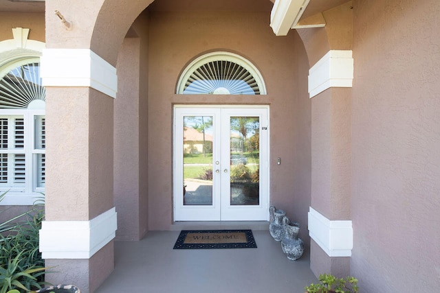 view of exterior entry featuring french doors