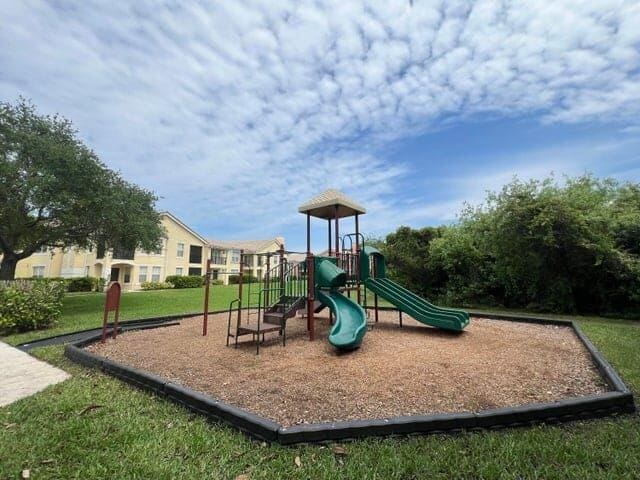 view of playground with a lawn