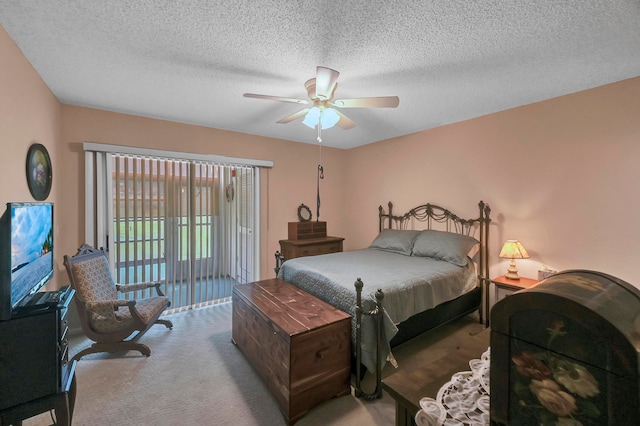 carpeted bedroom featuring ceiling fan, access to exterior, and a textured ceiling