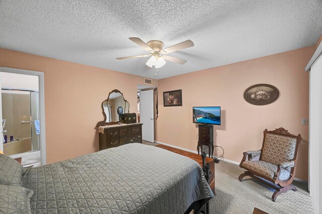 carpeted bedroom with a textured ceiling and ceiling fan