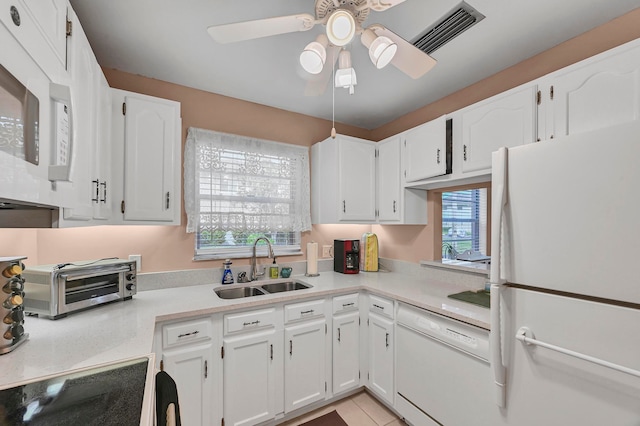 kitchen featuring white cabinetry, white appliances, light tile patterned floors, ceiling fan, and sink