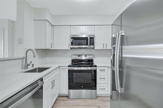 kitchen featuring a sink, light countertops, and stainless steel appliances