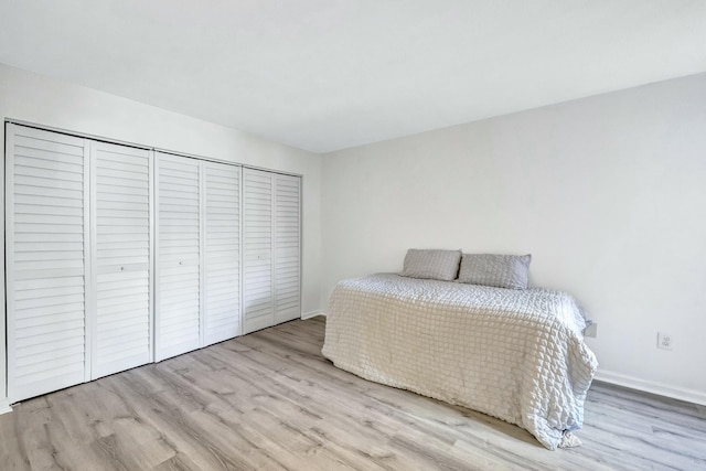 unfurnished bedroom featuring a closet and light wood-type flooring