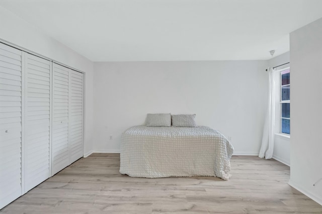 unfurnished bedroom with light hardwood / wood-style floors and a closet