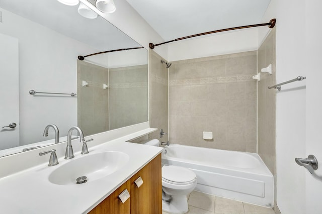 full bathroom featuring tile patterned floors, toilet, tiled shower / bath combo, and vanity