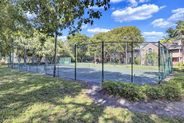 view of sport court featuring a lawn