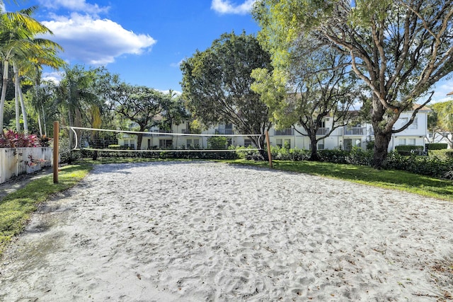 surrounding community featuring volleyball court and a lawn