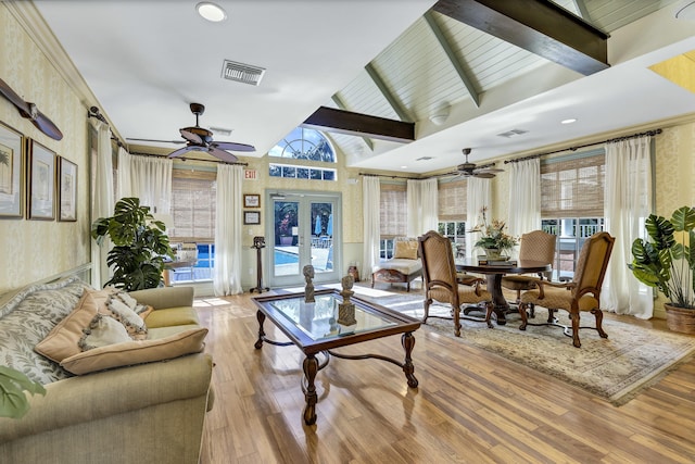 interior space with a healthy amount of sunlight, vaulted ceiling with beams, ceiling fan, and french doors