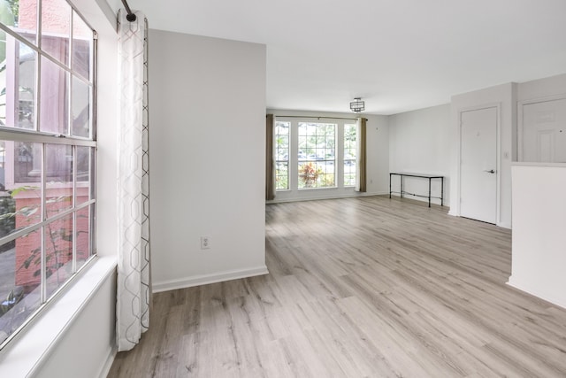 empty room with light hardwood / wood-style floors